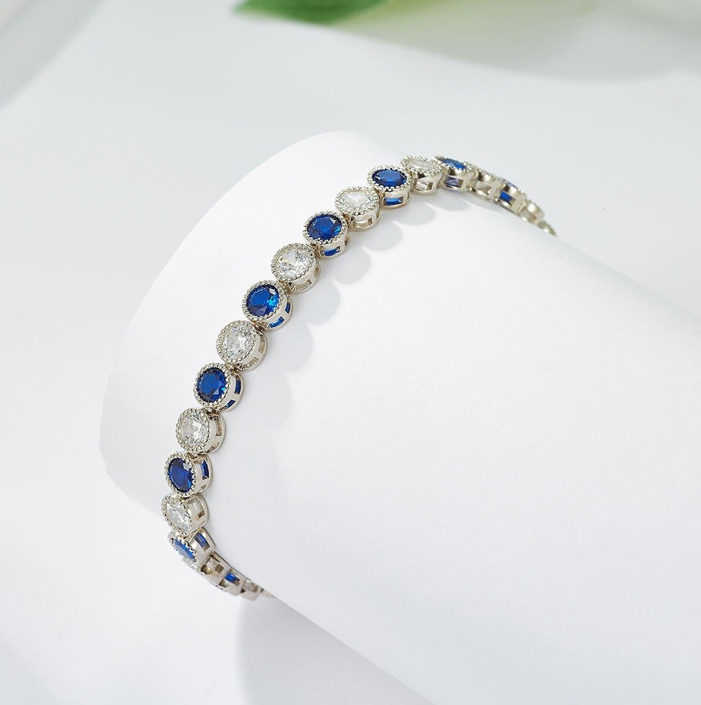 Silver bracelet with blue stones on a white background