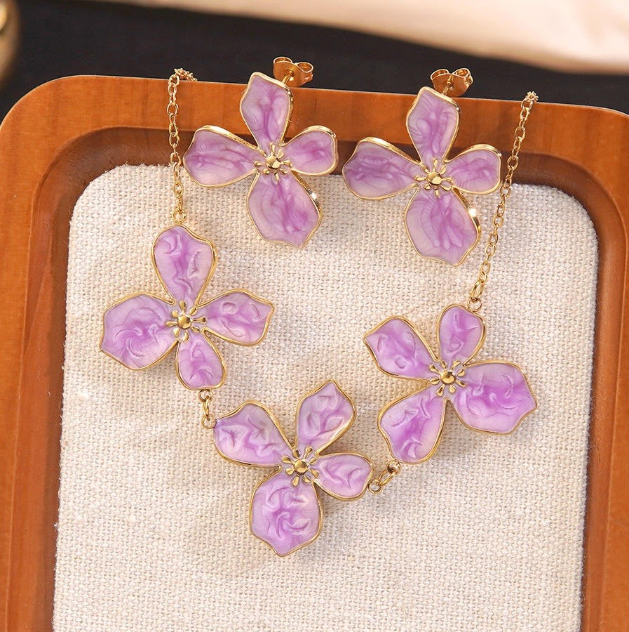 Necklace with purple flower pendants on a wooden stand