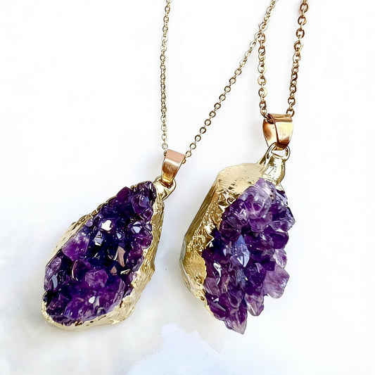 Two gold necklaces with purple amethyst pendants on a white background