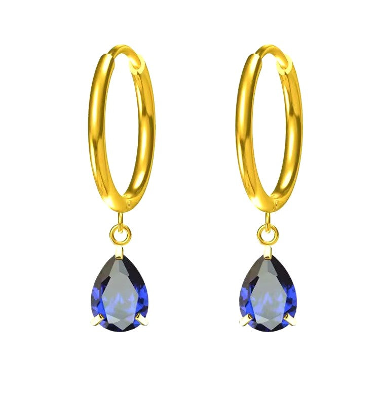 Gold hoop earrings with blue teardrop-shaped gemstones on a white background