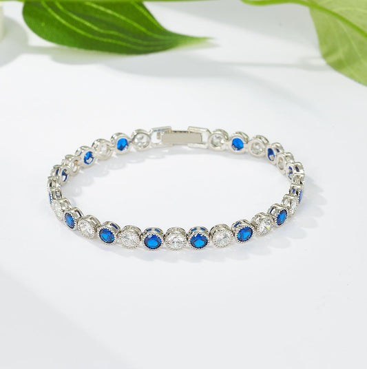 Silver bracelet with blue stones on a white background
