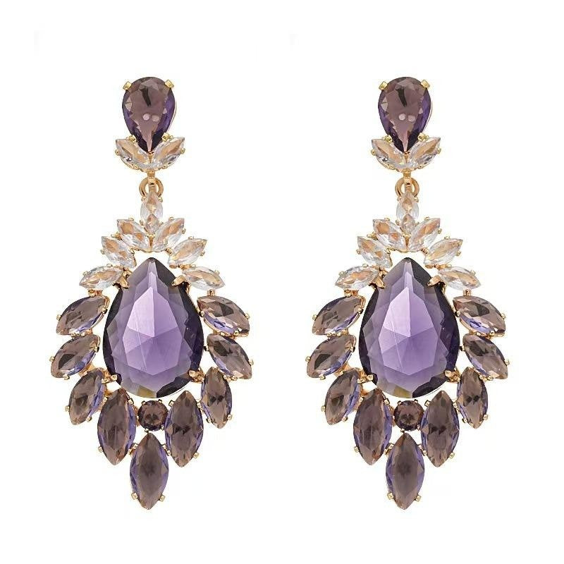 Pair of purple teardrop earrings with gold accents on a white background