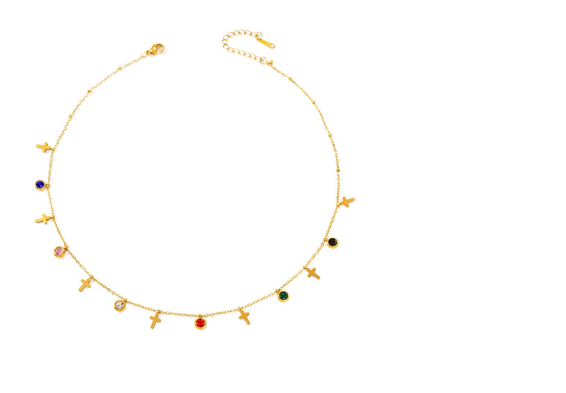 Gold necklace with colorful beads on a white background