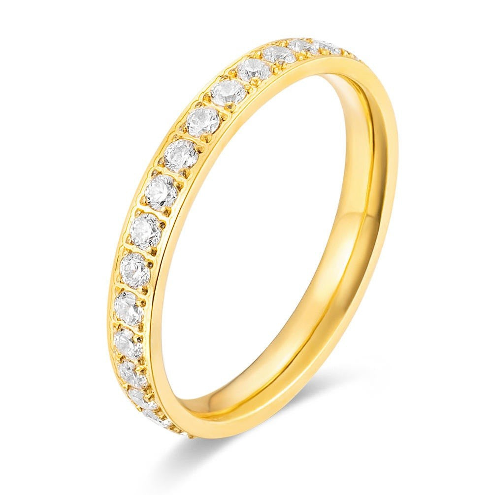 Gold ring with embedded diamonds on a white background