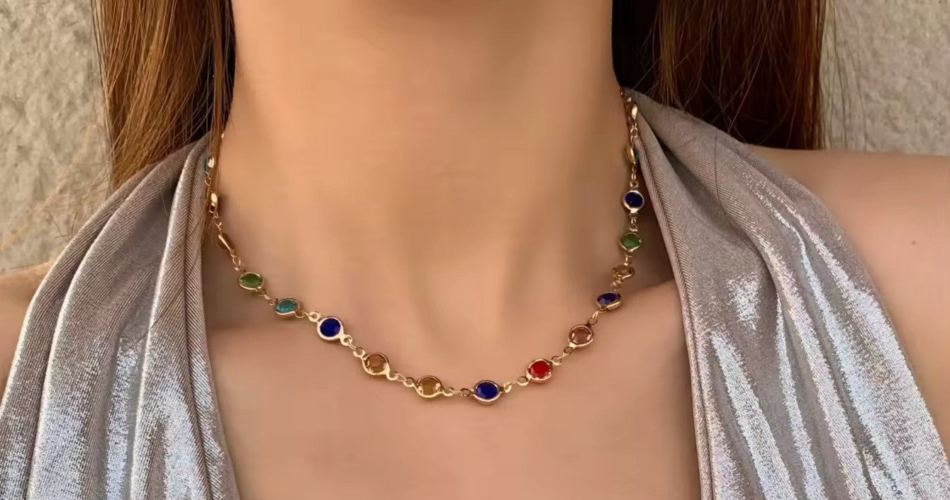 Necklace with colorful beads worn by a model against a neutral background