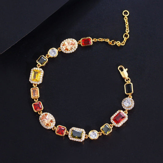 Gold bracelet with colorful gemstones on a black background