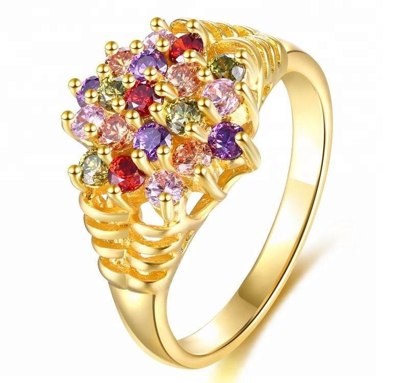 Gold ring with colorful gemstones on a white background