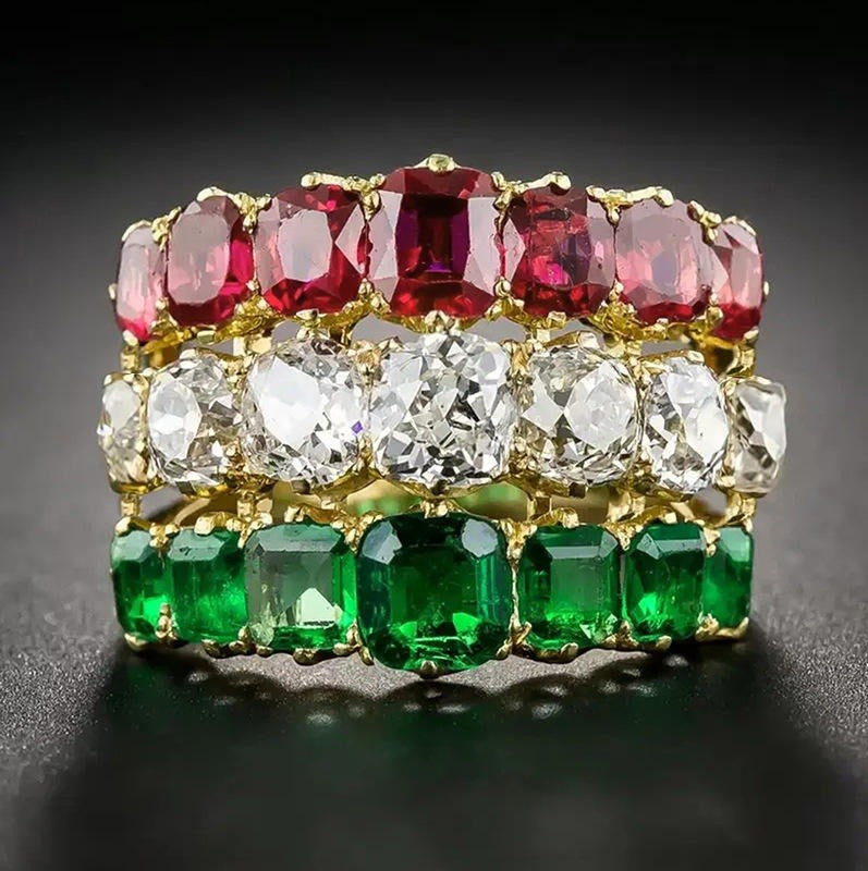 Ring with red and green gemstones on a dark background