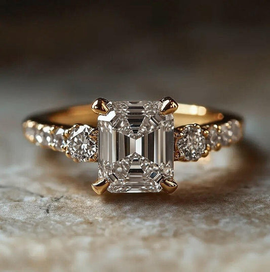 Gold ring with a large diamond and smaller diamonds on the sides, on a textured surface.