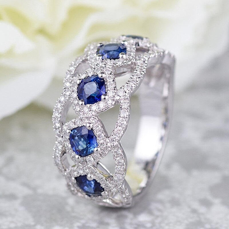 Silver ring with blue gemstones on a soft background