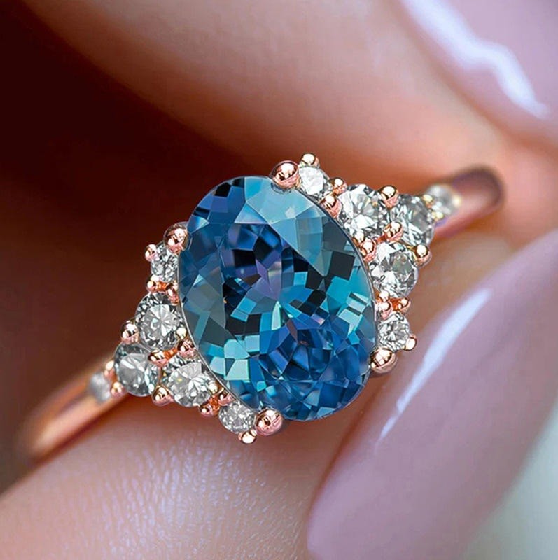 An oval-cut blue sapphire ring set in rose gold