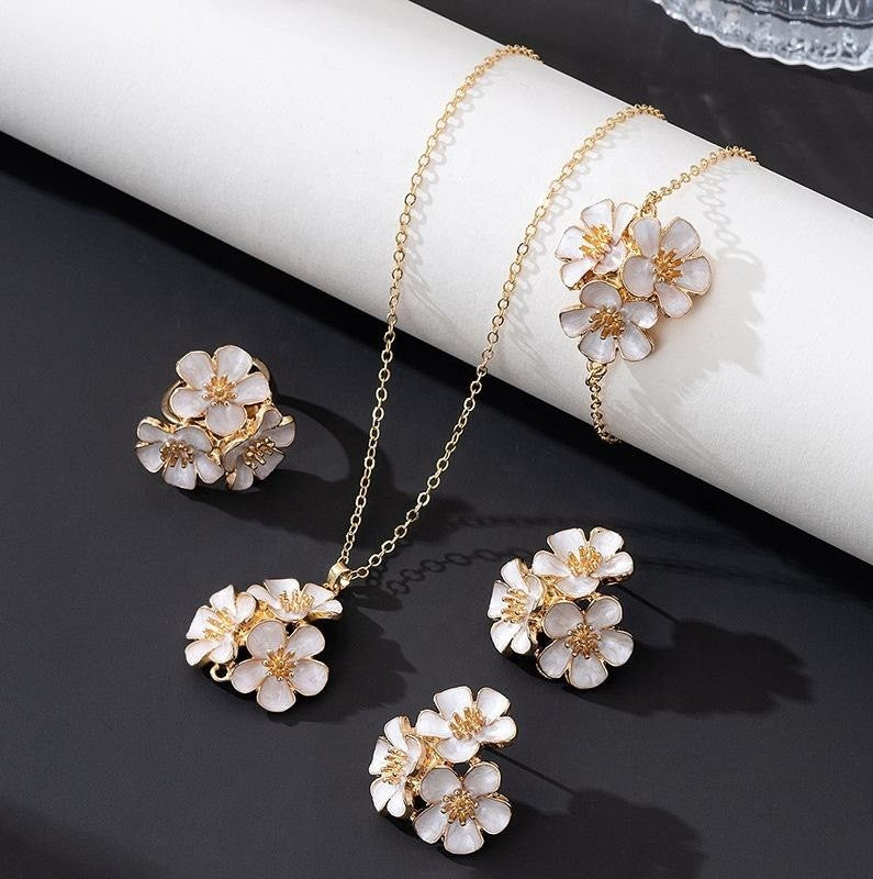 Floral jewelry set with necklace and earrings on a dark surface