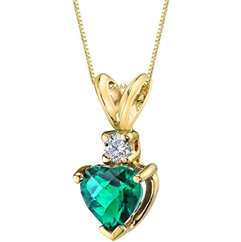 A yellow gold pendant necklace featuring a heart-shaped green gemstone and a small round clear accent stone, shown on a white background.