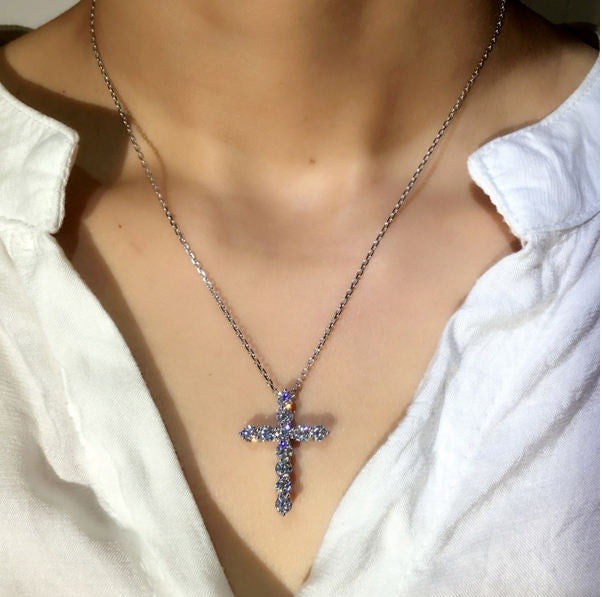 silver necklace with a sparking cross pendant