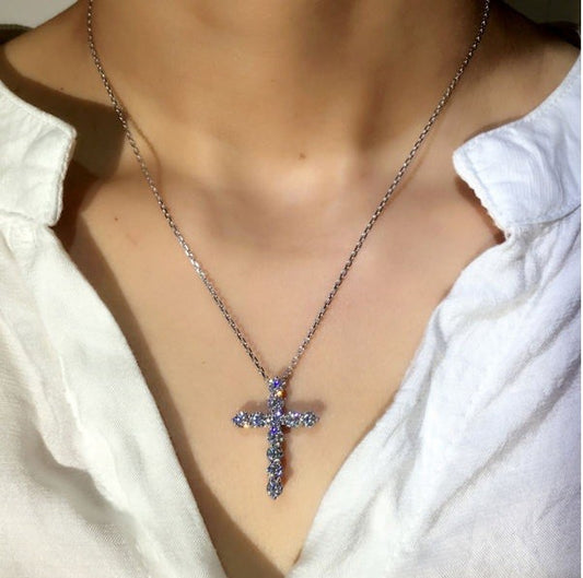 silver necklace with a sparking cross pendant