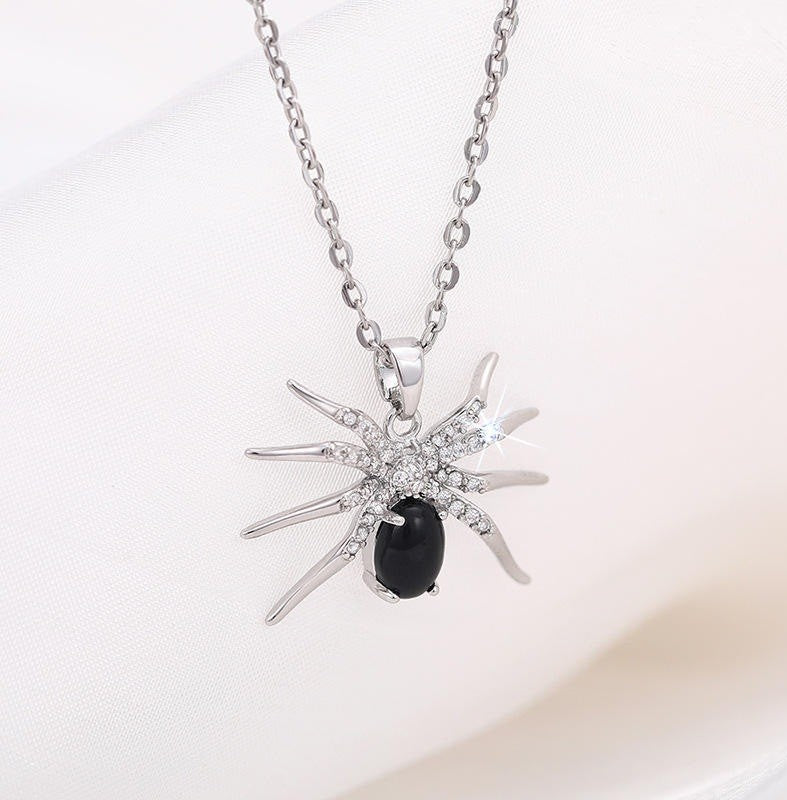 silver and black necklace in the shape of a spider pendant