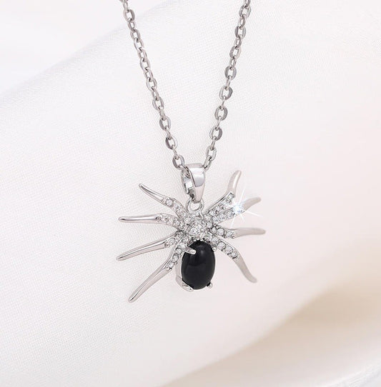 silver and black necklace in the shape of a spider pendant
