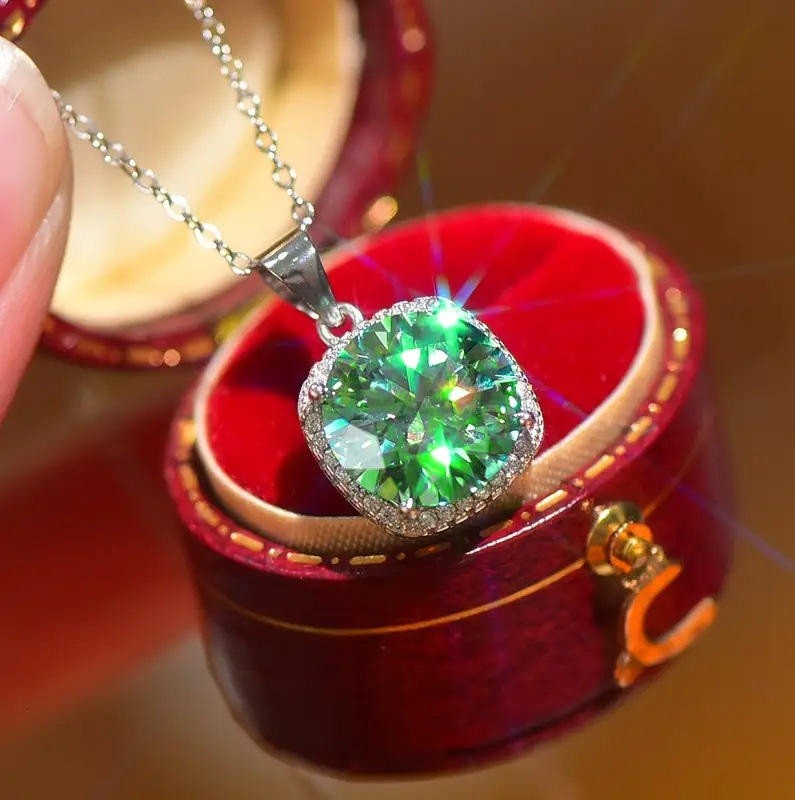 Green gemstone pendant in a red jewelry box