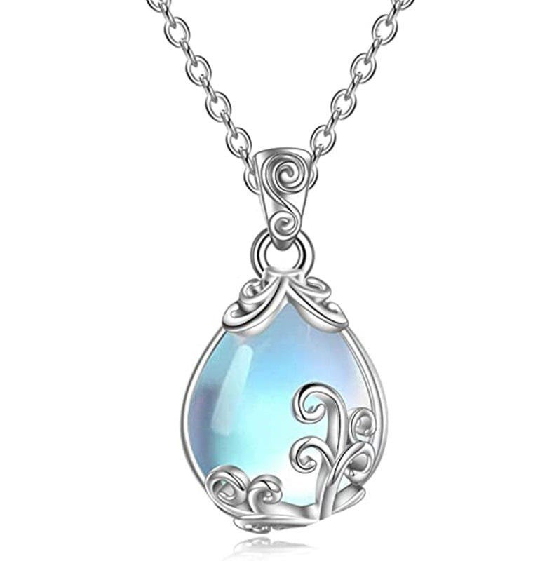 A silver teardrop pendant necklace featuring a light blue iridescent stone surrounded by ornate silver filigree details, suspended from a matching silver chain against a white background.
