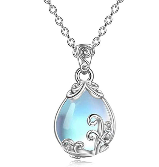 A silver teardrop pendant necklace featuring a light blue iridescent stone surrounded by ornate silver filigree details, suspended from a matching silver chain against a white background.