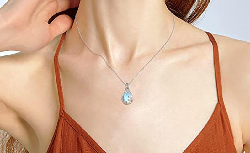 A silver plated necklace with blue gemstone