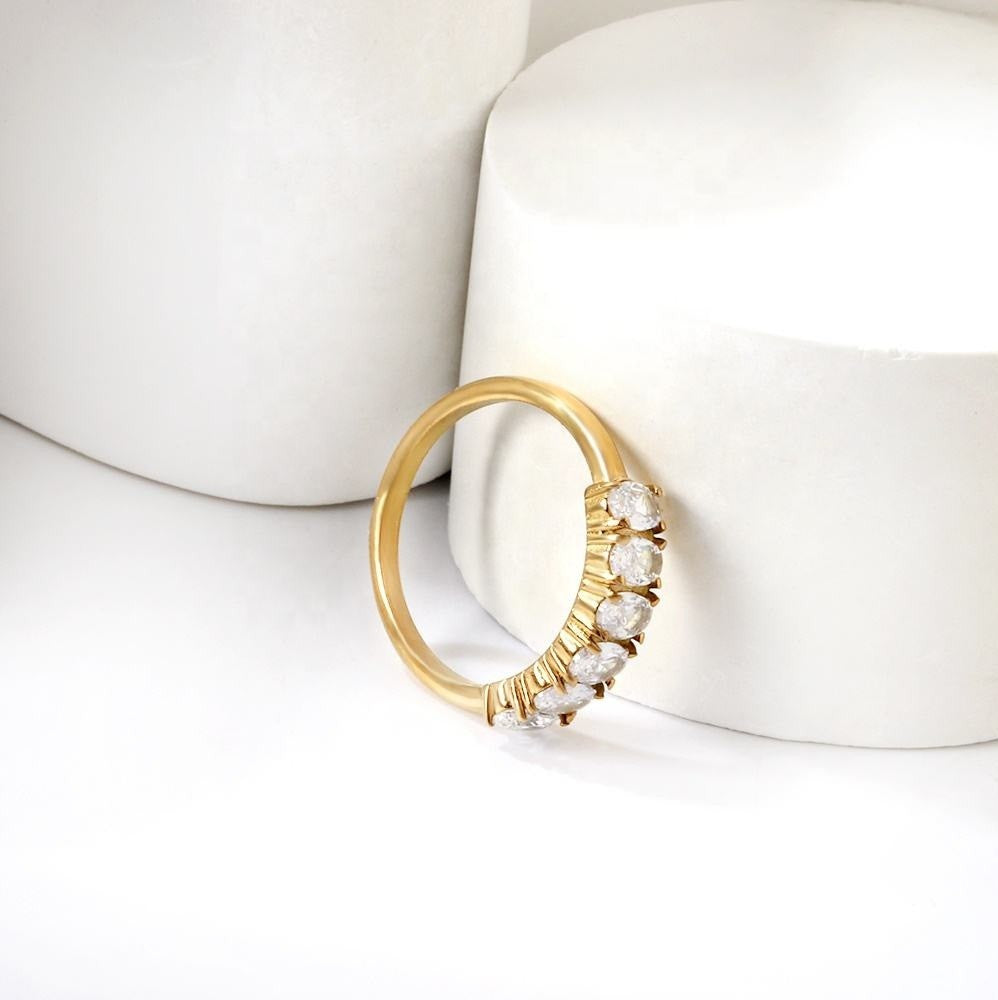 Gold ring with diamonds on a white surface