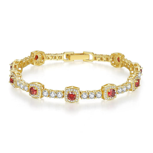Gold bracelet with red gemstones and clear stones on a white background