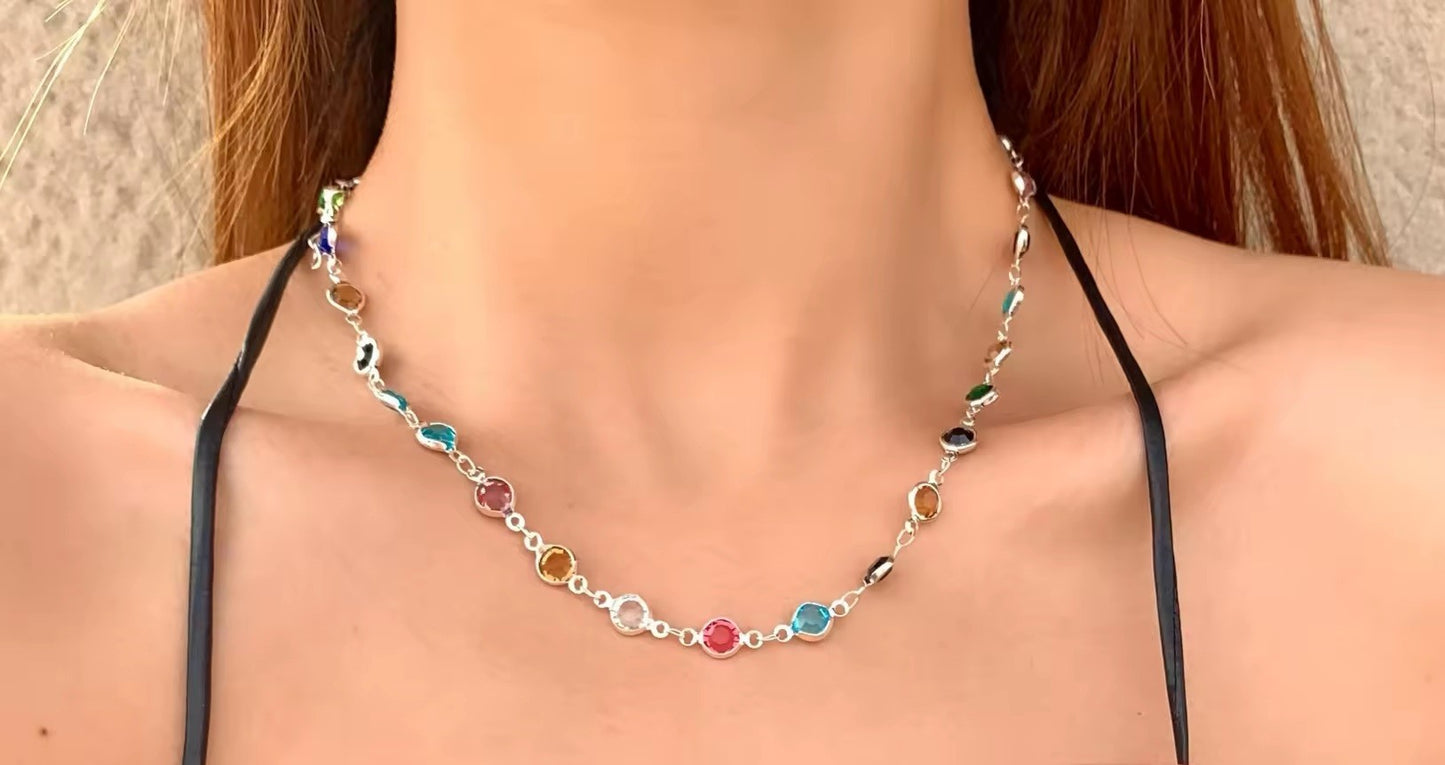 Necklace with colorful beads on a model wearing a black top.