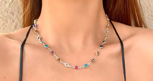 Necklace with colorful beads on a model wearing a black top.
